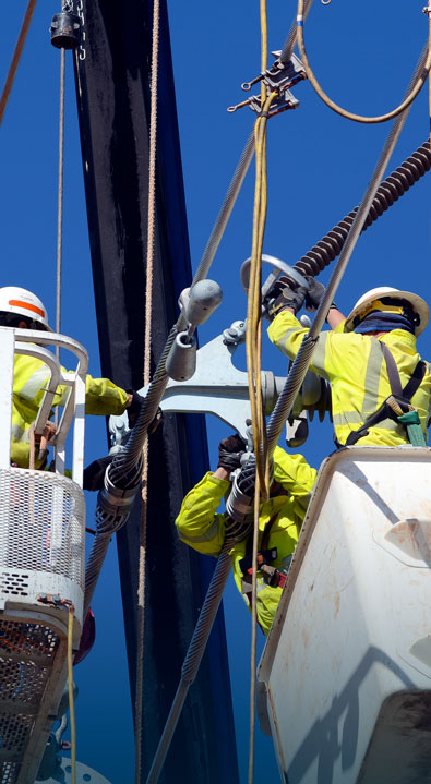 Lineworkers working on the transmission poles.